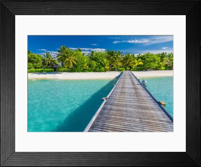 Framed Print : Beautiful Maldives island beach, palm trees and wooden pier over white sand a blue sea. Exotic vacation and holiday concept in Maldives island Framed Print : Beautiful Maldives island beach, palm trees and wooden pier over white sand a blue sea. Exotic vacation and holiday concept in Maldives island