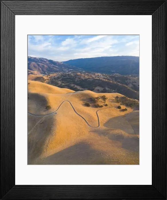 Framed Print : Golden sunlight shines on the rolling hills in Northern California. These beautiful, eroded hills turn green once winter brings seasonal rain Framed Print : Golden sunlight shines on the rolling hills in Northern California. These beautiful, eroded hills turn green once winter brings seasonal rain