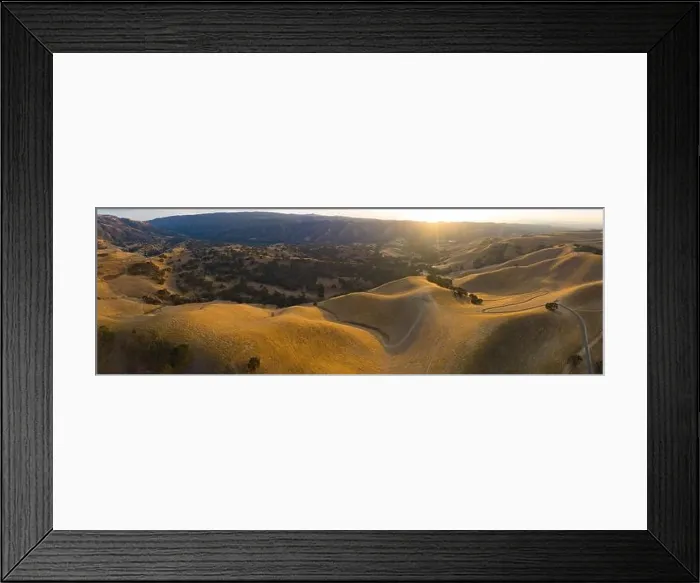 Framed Print : Golden sunlight shines on the rolling hills in Northern California. These beautiful, eroded hills turn green once winter brings seasonal rain Framed Print : Golden sunlight shines on the rolling hills in Northern California. These beautiful, eroded hills turn green once winter brings seasonal rain