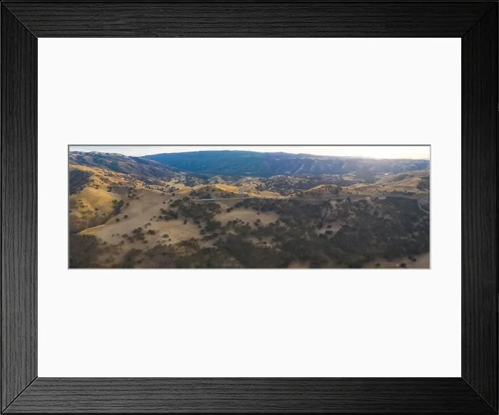 Framed Print : Golden sunlight shines on the rolling hills in Northern California. These beautiful, eroded hills turn green once winter brings seasonal rain Framed Print : Golden sunlight shines on the rolling hills in Northern California. These beautiful, eroded hills turn green once winter brings seasonal rain