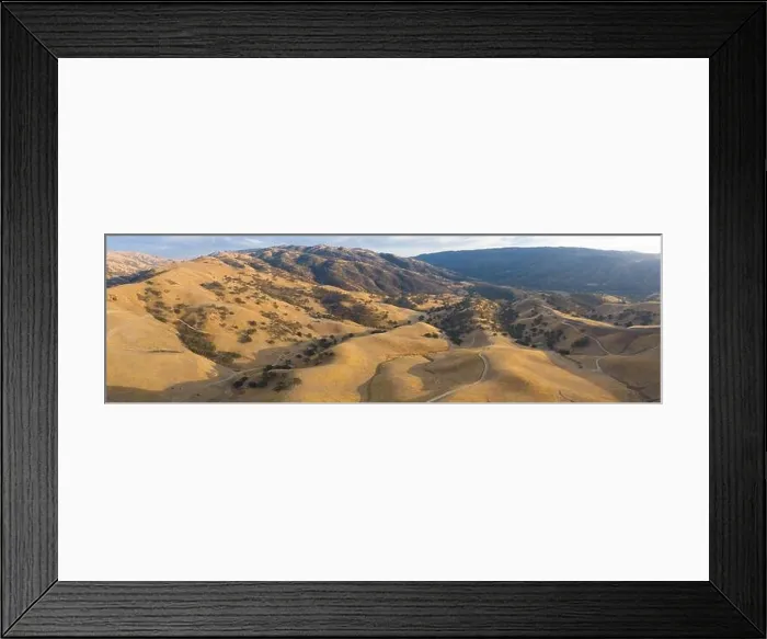 Framed Print : Golden sunlight shines on the rolling hills in Northern California. These beautiful, eroded hills turn green once winter brings seasonal rain Framed Print : Golden sunlight shines on the rolling hills in Northern California. These beautiful, eroded hills turn green once winter brings seasonal rain