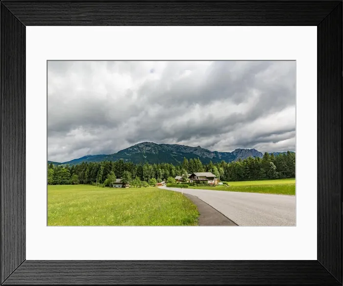 Framed Print : Alps in Austria. Wooden house before mountains green field and road through green pine forest Framed Print : Alps in Austria. Wooden house before mountains green field and road through green pine forest