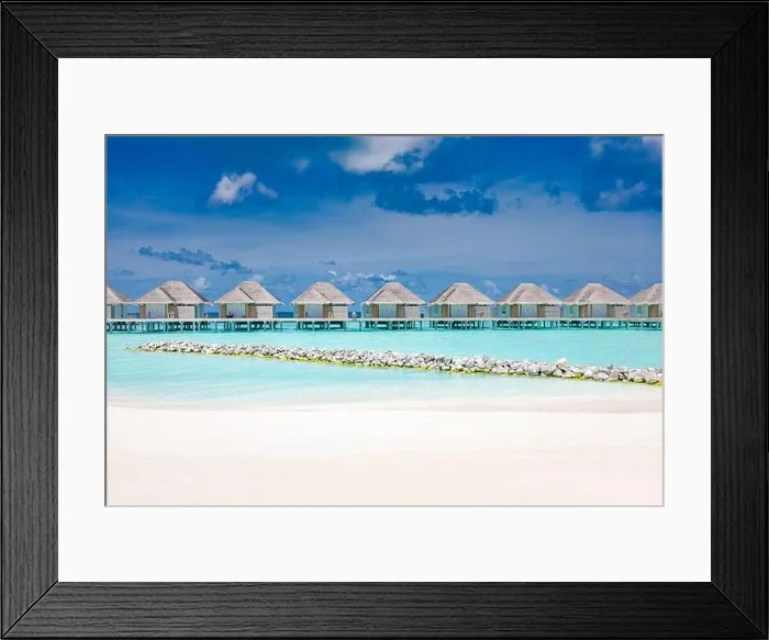 Framed Print : Water villas on tropical paradise island, Maldives. Beach with racks and white sand. Luxury summer travel vacation destination. Relaxing beach scenery Framed Print : Water villas on tropical paradise island, Maldives. Beach with racks and white sand. Luxury summer travel vacation destination. Relaxing beach scenery