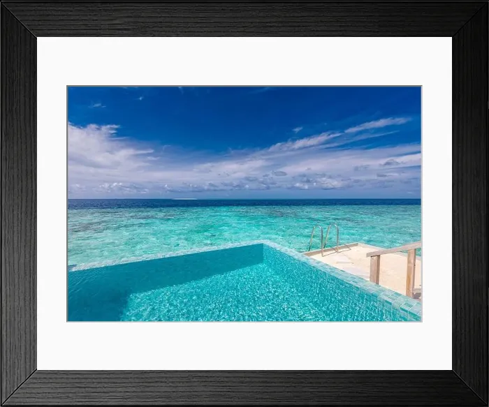 Framed Print : Infinity pool on the bright summer day. Infinity swimming pool in luxury hotel resort, tropical seascape, lagoon. Amazing summer vacation leisure view Framed Print : Infinity pool on the bright summer day. Infinity swimming pool in luxury hotel resort, tropical seascape, lagoon. Amazing summer vacation leisure view