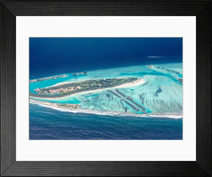 Framed Print : Amazing bird eyes view in Maldives from plane or drone. Luxury resort hotel water villas bungalows. Summer vacation holiday landscape destination