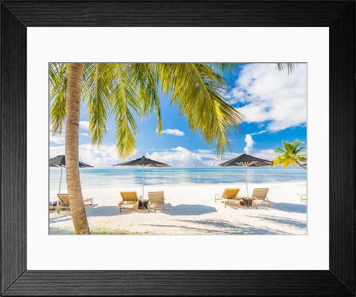 Framed Print : View of luxury beach scene with white fashion deckchairs on the beach.Umbrellas and blue sky with palm trees. Exotic travel destination banner concept Framed Print : View of luxury beach scene with white fashion deckchairs on the beach.Umbrellas and blue sky with palm trees. Exotic travel destination banner concept