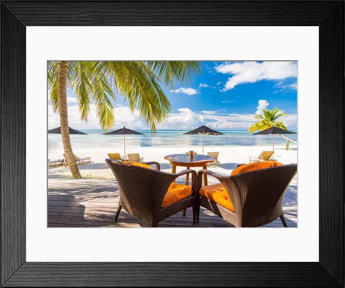 Framed Print : View of luxury beach scene with white fashion deckchairs on the beach.Umbrellas and blue sky with palm trees. Exotic travel destination banner concept Framed Print : View of luxury beach scene with white fashion deckchairs on the beach.Umbrellas and blue sky with palm trees. Exotic travel destination banner concept