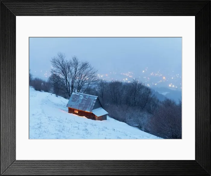 Framed Print : Fantastic winter landscape with glowing wooden house against the backdrop of glowing city lights in fog. Cozy cabin in Carpathian mountains Framed Print : Fantastic winter landscape with glowing wooden house against the backdrop of glowing city lights in fog. Cozy cabin in Carpathian mountains