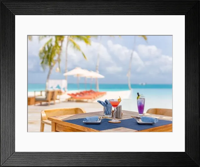 Framed Print : Luxury resort outdoor restaurant table with beach chairs, close to infinity pool on tropical landscape. Exotic summer vacation holiday background Framed Print : Luxury resort outdoor restaurant table with beach chairs, close to infinity pool on tropical landscape. Exotic summer vacation holiday background