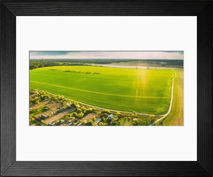 Framed Print : Countryside Rural Landscape With Small Village, Gardens And Green Field In Spring Summer Day. Elevated View. Panorama Framed Print : Countryside Rural Landscape With Small Village, Gardens And Green Field In Spring Summer Day. Elevated View. Panorama