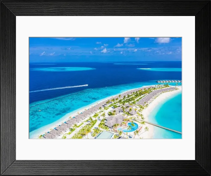 Framed Print : Aerial view of a tropical island in turquoise water. Luxurious over water villas on tropical island resort. Maldives aerial landscape holiday vacation Framed Print : Aerial view of a tropical island in turquoise water. Luxurious over water villas on tropical island resort. Maldives aerial landscape holiday vacation