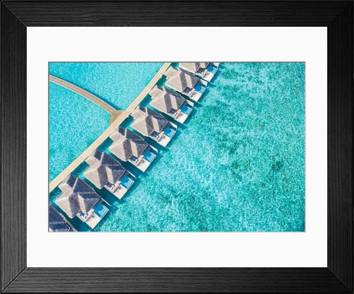 Framed Print : Atolls and islands in Maldives. Tropical island at Maldives with luxury water villas, bungalows over amazing blue sea. Summer vacation, aerial view Framed Print : Atolls and islands in Maldives. Tropical island at Maldives with luxury water villas, bungalows over amazing blue sea. Summer vacation, aerial view