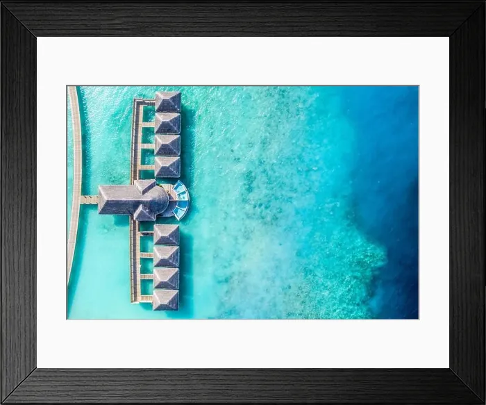Framed Print : Atolls and islands in Maldives. Tropical island at Maldives with luxury water villas, bungalows over amazing blue sea. Summer vacation, aerial view Framed Print : Atolls and islands in Maldives. Tropical island at Maldives with luxury water villas, bungalows over amazing blue sea. Summer vacation, aerial view