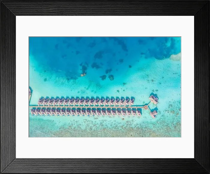 Framed Print : Atolls and islands in Maldives. Tropical island at Maldives with luxury water villas, bungalows over amazing blue sea. Summer vacation, aerial view Framed Print : Atolls and islands in Maldives. Tropical island at Maldives with luxury water villas, bungalows over amazing blue sea. Summer vacation, aerial view