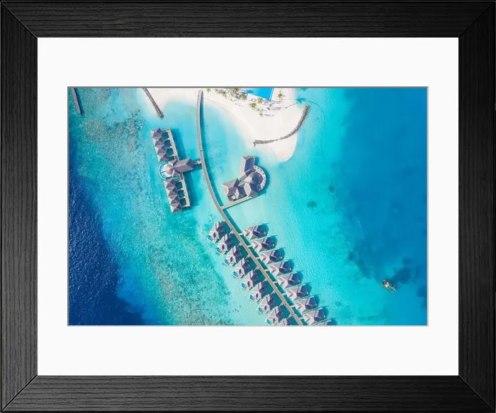Framed Print : Atolls and islands in Maldives. Tropical island at Maldives with luxury water villas, bungalows over amazing blue sea. Summer vacation, aerial view Framed Print : Atolls and islands in Maldives. Tropical island at Maldives with luxury water villas, bungalows over amazing blue sea. Summer vacation, aerial view