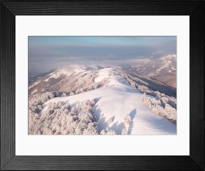 Framed Print : Amazing aerial view of mountains range, meadows and snow-capped peaks in winter time. Forest with frost glowing with bright warm sunrise light Framed Print : Amazing aerial view of mountains range, meadows and snow-capped peaks in winter time. Forest with frost glowing with bright warm sunrise light