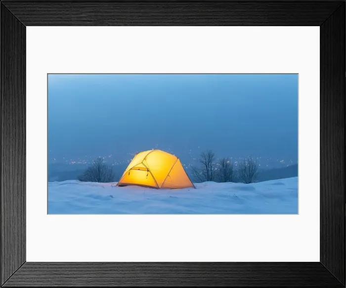 Framed Print : Yellow tent lighted from the inside against the backdrop of glowing city lights in fog. Amazing snowy landscape. Tourists camp in winter mountains Framed Print : Yellow tent lighted from the inside against the backdrop of glowing city lights in fog. Amazing snowy landscape. Tourists camp in winter mountains