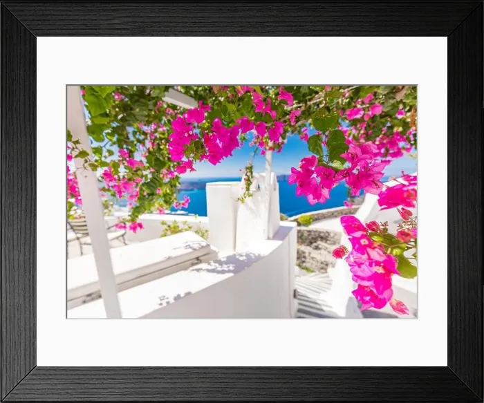 Framed Print : Traditional famous white blue houses wih flowers under sunny weather over the Caldera, Aegean sea. Beautiful summer landscape, sea view, luxury travel Framed Print : Traditional famous white blue houses wih flowers under sunny weather over the Caldera, Aegean sea. Beautiful summer landscape, sea view, luxury travel