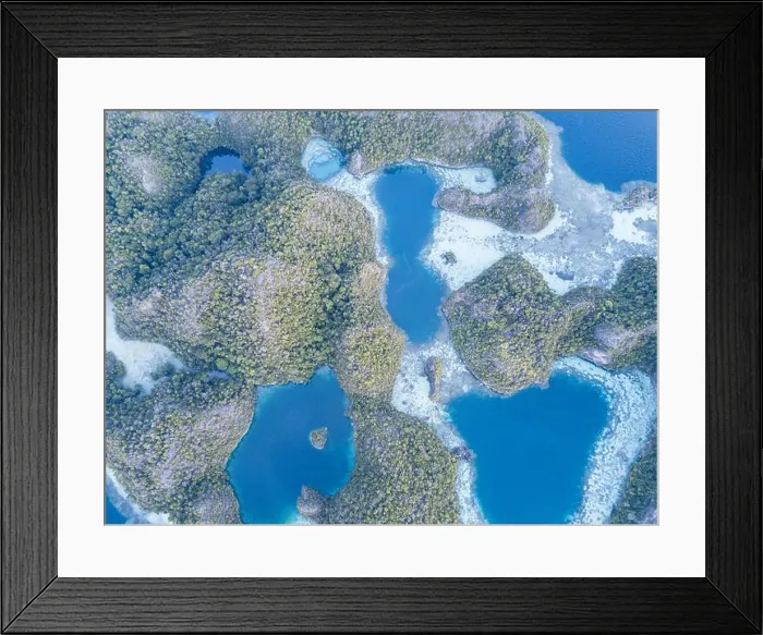 Framed Print : Beautiful limestone islands rise from the calm seas of Raja Ampat, Indonesia. This remote region is known for its extraordinary marine biodiversity Framed Print : Beautiful limestone islands rise from the calm seas of Raja Ampat, Indonesia. This remote region is known for its extraordinary marine biodiversity