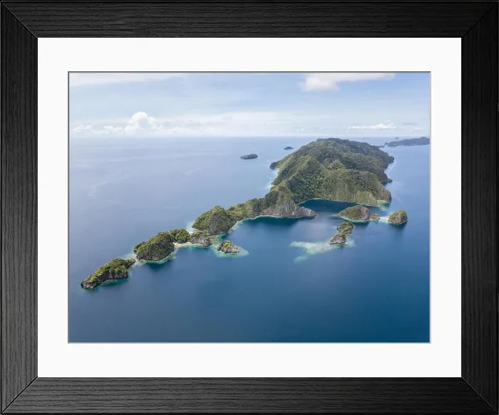 Framed Print : Amazing limestone islands rise from the calm seascape around Misool, Raja Ampat, Indonesia. This tropical region harbors amazing marine biodiversity Framed Print : Amazing limestone islands rise from the calm seascape around Misool, Raja Ampat, Indonesia. This tropical region harbors amazing marine biodiversity