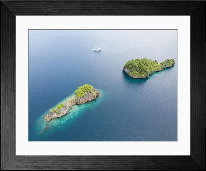 Framed Print : Amazing limestone islands rise from the calm seascape around Misool, Raja Ampat, Indonesia. This tropical region harbors amazing marine biodiversity Framed Print : Amazing limestone islands rise from the calm seascape around Misool, Raja Ampat, Indonesia. This tropical region harbors amazing marine biodiversity