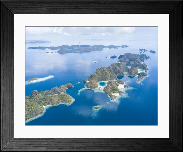 Framed Print : Amazing limestone islands rise from the calm seascape around Misool, Raja Ampat, Indonesia. This tropical region harbors amazing marine biodiversity Framed Print : Amazing limestone islands rise from the calm seascape around Misool, Raja Ampat, Indonesia. This tropical region harbors amazing marine biodiversity