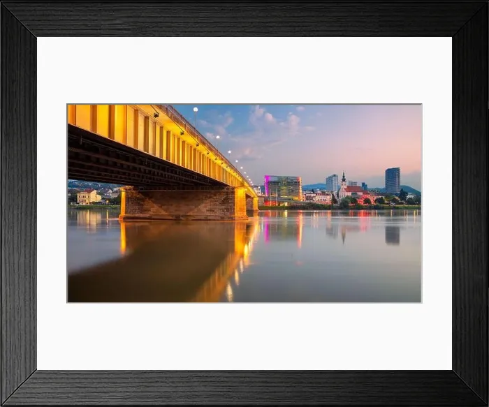 Framed Print : Linz, Austria. Cityscape image of riverside Linz, Austria at summer sunrise with reflection of the city lights in Danube river Framed Print : Linz, Austria. Cityscape image of riverside Linz, Austria at summer sunrise with reflection of the city lights in Danube river