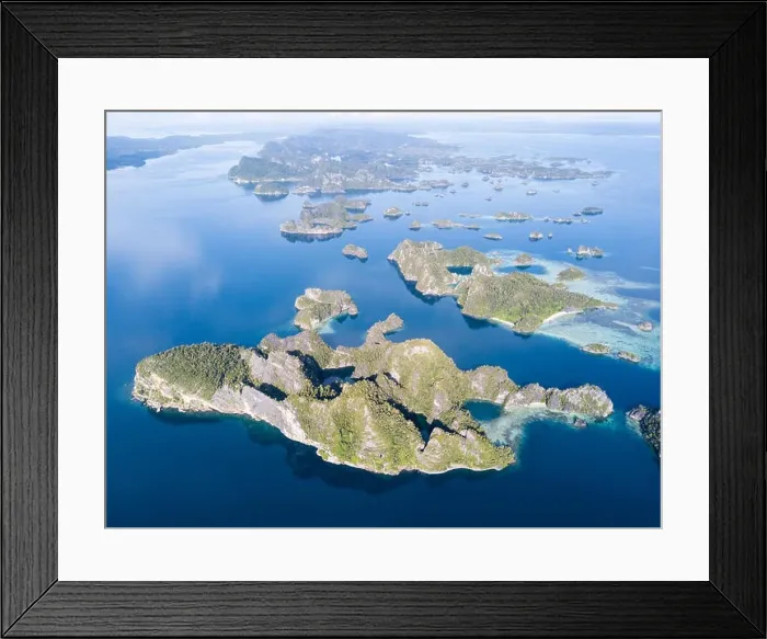 Framed Print : Amazing limestone islands rise from the calm seascape around Misool, Raja Ampat, Indonesia. This tropical region harbors amazing marine biodiversity Framed Print : Amazing limestone islands rise from the calm seascape around Misool, Raja Ampat, Indonesia. This tropical region harbors amazing marine biodiversity
