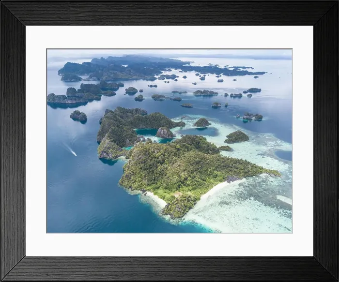 Framed Print : The remote limestone islands of Misool in Raja Ampat are surrounded by calm seas and healthy reefs. This tropical region has high marine biodiversity Framed Print : The remote limestone islands of Misool in Raja Ampat are surrounded by calm seas and healthy reefs. This tropical region has high marine biodiversity