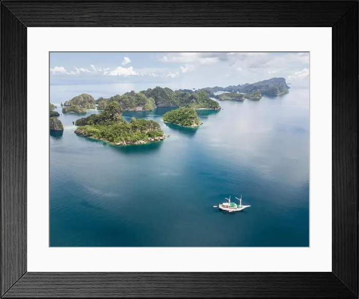 Framed Print : The remote limestone islands of Misool in Raja Ampat are surrounded by calm seas and healthy reefs. This tropical region has high marine biodiversity Framed Print : The remote limestone islands of Misool in Raja Ampat are surrounded by calm seas and healthy reefs. This tropical region has high marine biodiversity