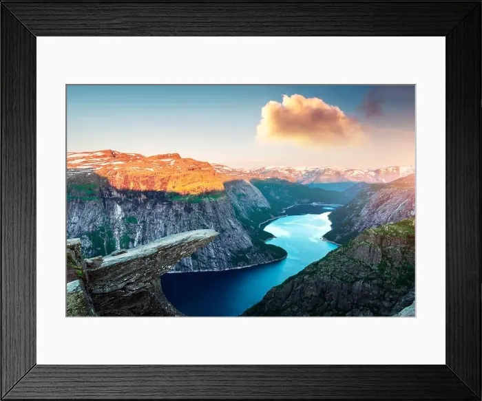 Framed Print : Breathtaking view of Trolltunga rock - most spectacular and famous scenic cliff in Norway. Picturesque landscape with sunset sky and clear lake Framed Print : Breathtaking view of Trolltunga rock - most spectacular and famous scenic cliff in Norway. Picturesque landscape with sunset sky and clear lake