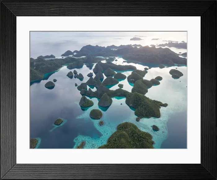 Framed Print : Beautiful limestone islands are fringed by coral reefs in Wayag, Raja Ampat, Indonesia. This region is known for its amazing marine biodiversity Framed Print : Beautiful limestone islands are fringed by coral reefs in Wayag, Raja Ampat, Indonesia. This region is known for its amazing marine biodiversity