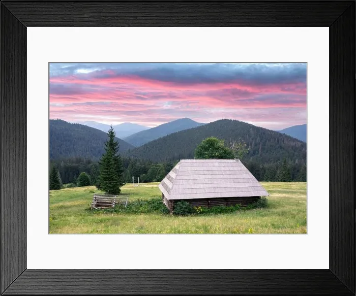 Framed Print : Picturesque summer meadow with old wooden house and purple sunset sky in the Carpathian mountains, Ukraine. Landscape photography
