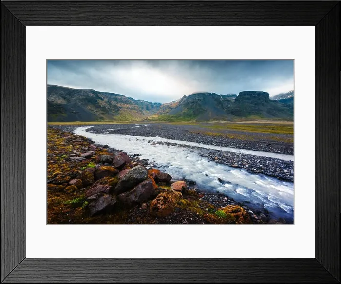 Framed Print : Typical Iceland landscape with river and mountains. Dramatic sky and red stones on a foreground Framed Print : Typical Iceland landscape with river and mountains. Dramatic sky and red stones on a foreground