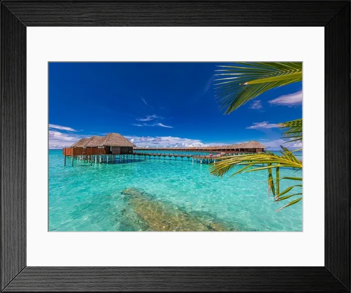 Framed Print : Stunning tourism landscape. Luxurious beach resort, palm trees over calm sea water, beach villas and blue sky. Romantic destination, vacation, holiday Framed Print : Stunning tourism landscape. Luxurious beach resort, palm trees over calm sea water, beach villas and blue sky. Romantic destination, vacation, holiday