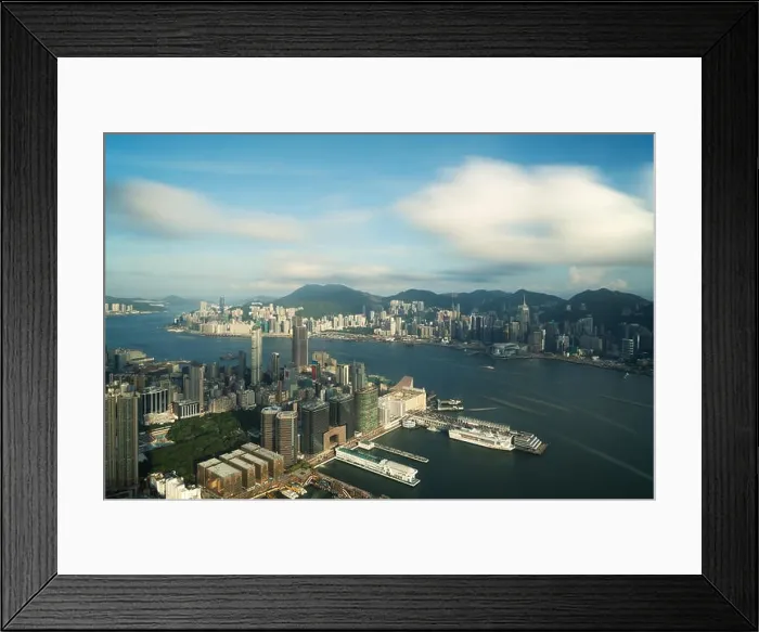 Framed Print : Aerial view of Hong Kong skyline and Victoria Harbor with blue sky in Hong Kong. Asia Framed Print : Aerial view of Hong Kong skyline and Victoria Harbor with blue sky in Hong Kong. Asia