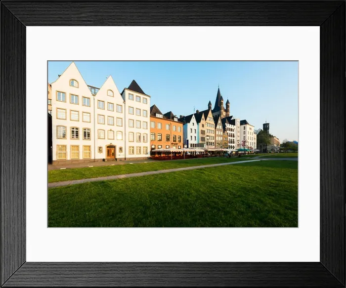Framed Print : Houses and park in Cologne, Germany. Many of them are colourful, they are facing a public park with green grass and some trees. There is a Cologne bel Framed Print : Houses and park in Cologne, Germany. Many of them are colourful, they are facing a public park with green grass and some trees. There is a Cologne bel