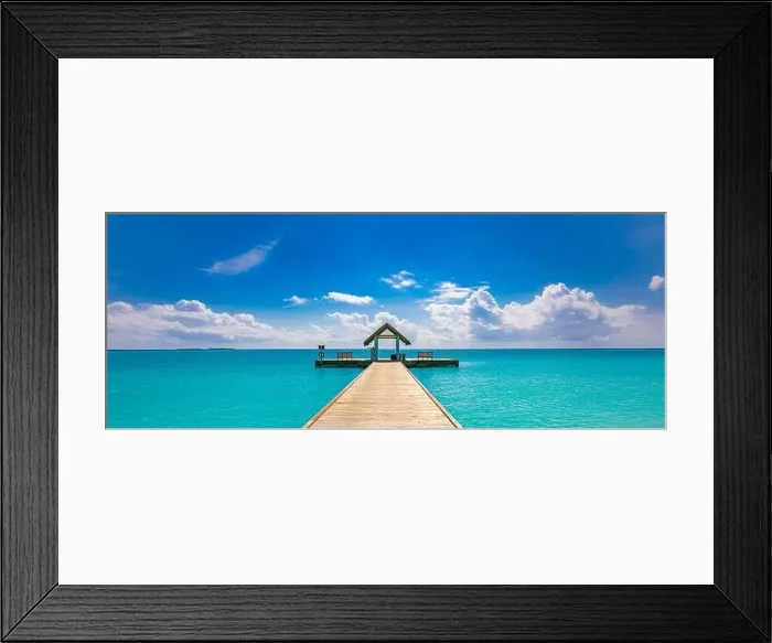 Framed Print : Amazing seascape panorama at Maldives. Luxury resort villas seascape under sunny blue sky. Water bungalow and jetty, ocean lagoon Framed Print : Amazing seascape panorama at Maldives. Luxury resort villas seascape under sunny blue sky. Water bungalow and jetty, ocean lagoon