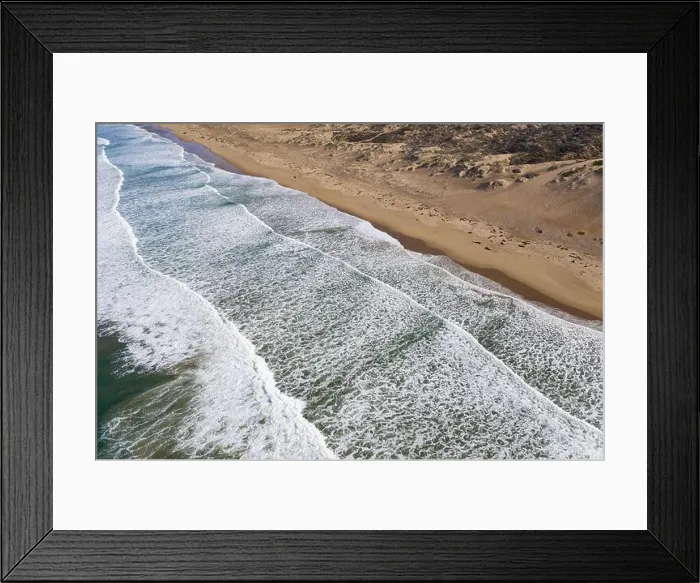 Framed Print : The Pacific Ocean washes onto a beach and sand dunes in Morro Bay, California. This coastal part of Central California is known for its scenery Framed Print : The Pacific Ocean washes onto a beach and sand dunes in Morro Bay, California. This coastal part of Central California is known for its scenery