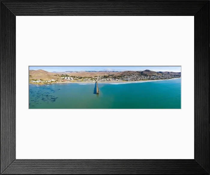 Framed Print : A long pier reaches out into the Pacific Coast in the quaint city of Cayucos, California. This central California region is known for its scenic Framed Print : A long pier reaches out into the Pacific Coast in the quaint city of Cayucos, California. This central California region is known for its scenic