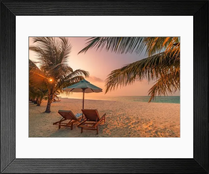 Framed Print : Beautiful tropical sunset scenery, two sun beds, loungers, umbrella under palm tree. White sand, sea view with horizon, colorful twilight sky calm Framed Print : Beautiful tropical sunset scenery, two sun beds, loungers, umbrella under palm tree. White sand, sea view with horizon, colorful twilight sky calm