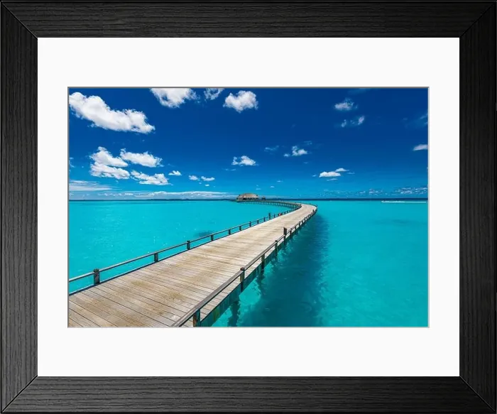 Framed Print : Maldives beach resort panoramic landscape. Long wooden pier with amazing sea beach. Tropical paradise, summer vacation, travel destination Framed Print : Maldives beach resort panoramic landscape. Long wooden pier with amazing sea beach. Tropical paradise, summer vacation, travel destination