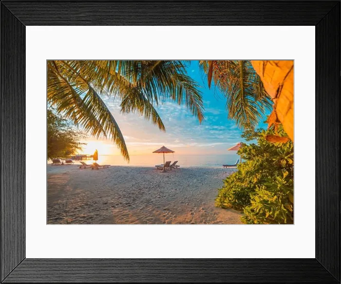 Framed Print : Beautiful tropical sunset scenery, two sun beds, loungers, umbrella under palm tree. White sand, sea view with horizon, colorful twilight sky, calm Framed Print : Beautiful tropical sunset scenery, two sun beds, loungers, umbrella under palm tree. White sand, sea view with horizon, colorful twilight sky, calm