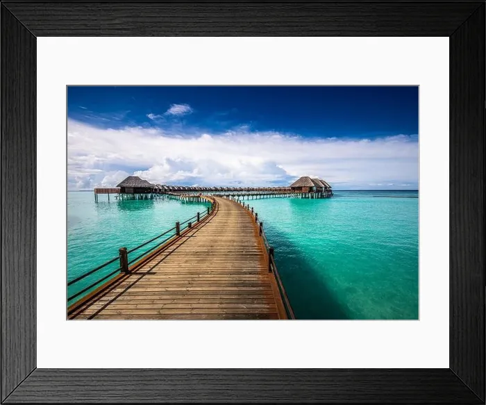 Framed Print : Maldives villa on piles on water, luxury summer travel. Morning sunlight, long wooden jetty under cloudy blue sky. Luxury bungalows, amazing sea Framed Print : Maldives villa on piles on water, luxury summer travel. Morning sunlight, long wooden jetty under cloudy blue sky. Luxury bungalows, amazing sea