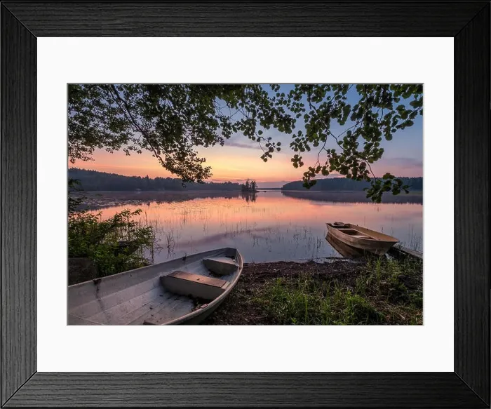 Framed Print : Scenic sunset view with two row boat and idyllic lake at summer night in Finland Framed Print : Scenic sunset view with two row boat and idyllic lake at summer night in Finland