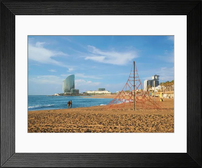 Framed Print : Pedestrians walk along Barceloneta Beach in Barcelona with colorful sky at sunrise. Seafront, beach, coast in Spain. Suburb of Barcelona, Catalonia Framed Print : Pedestrians walk along Barceloneta Beach in Barcelona with colorful sky at sunrise. Seafront, beach, coast in Spain. Suburb of Barcelona, Catalonia