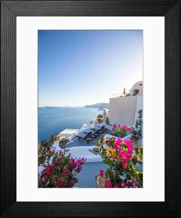 Framed Print : Oia town on Santorini island, Greece. Traditional famous white blue houses with flowers under sunny weather caldera, Aegean sea. Beautiful summer view Framed Print : Oia town on Santorini island, Greece. Traditional famous white blue houses with flowers under sunny weather caldera, Aegean sea. Beautiful summer view