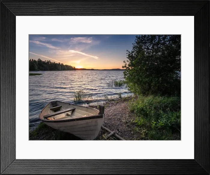Framed Print : Scenic landscape with idyllic lake view and boat at summer evening in Finland Framed Print : Scenic landscape with idyllic lake view and boat at summer evening in Finland
