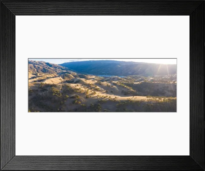 Framed Print : Golden sunlight shines on the rolling hills in Northern California. These beautiful, eroded hills turn green once winter brings seasonal rain Framed Print : Golden sunlight shines on the rolling hills in Northern California. These beautiful, eroded hills turn green once winter brings seasonal rain
