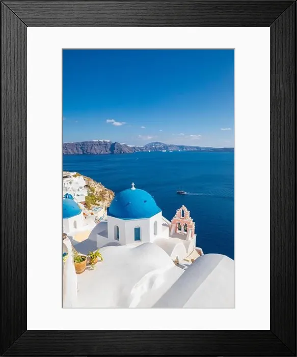 Framed Print : Beautiful Oia town on Santorini island, Greece. Traditional white architecture and greek orthodox churches with blue domes over Caldera, Aegean sea Framed Print : Beautiful Oia town on Santorini island, Greece. Traditional white architecture and greek orthodox churches with blue domes over Caldera, Aegean sea